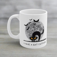 Thumbnail for funny halloween cat mug with the image of a black cat, bats, and a full moon, and the text I have a bat catitude