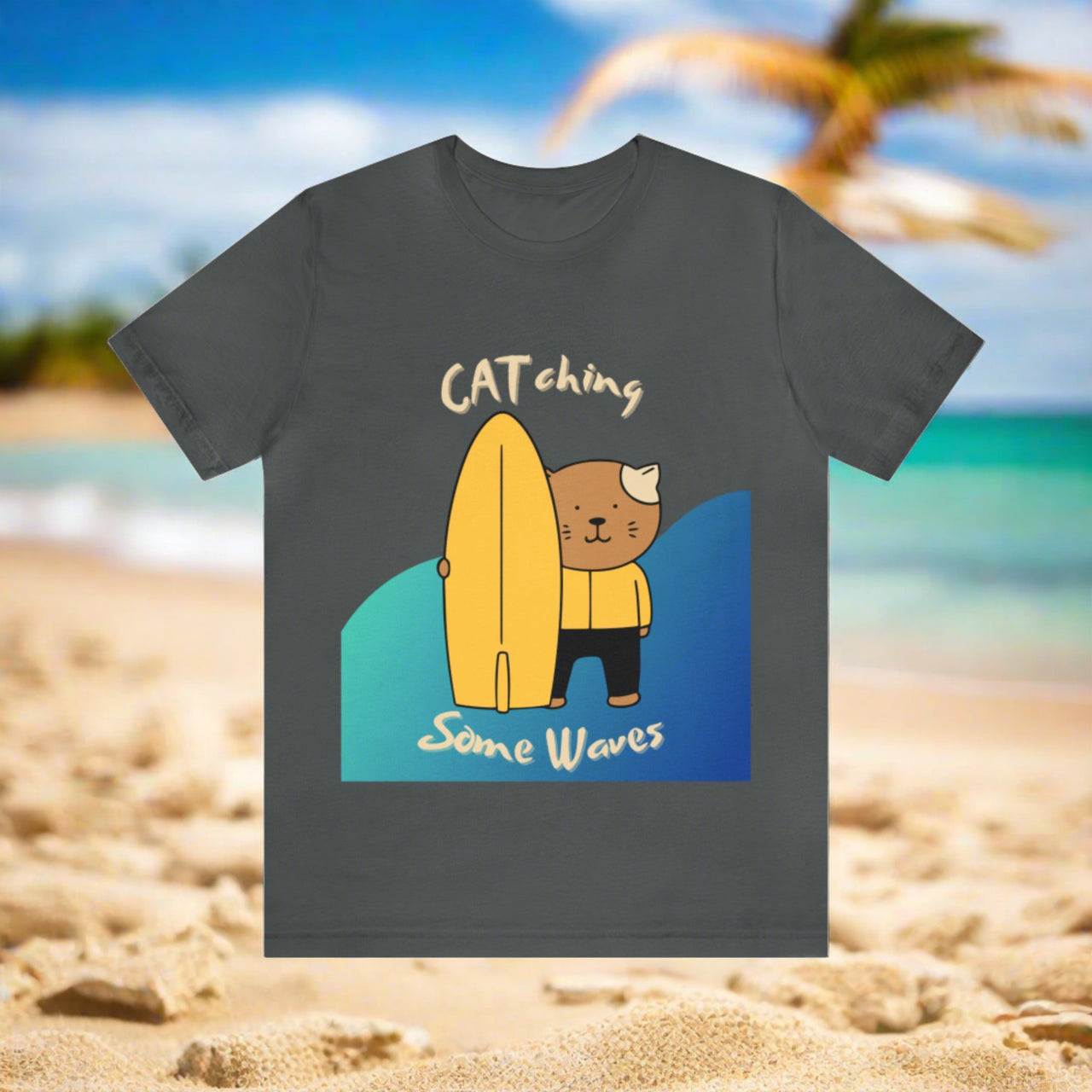 cute cat t-shirt, funny pun cat shirt, graphic of cartoon cat with surfboard and text that says CATching some waves